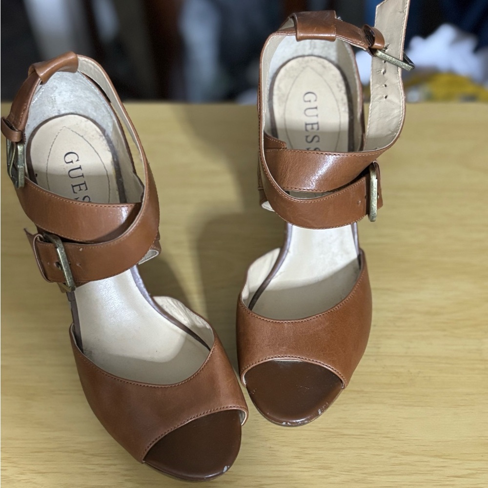 Used- Women’s brown Guess buckle up on the side heels size 7M.